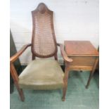 An oak sewing table together with an occasional chair, with cane back.