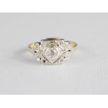 An early 20th century Art Deco style ring with central diamond, set in platinum setting, on an