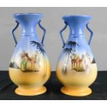 A pair of Athens porcelain vases, kitch, depicting Egyptian scenes. 26cm high.