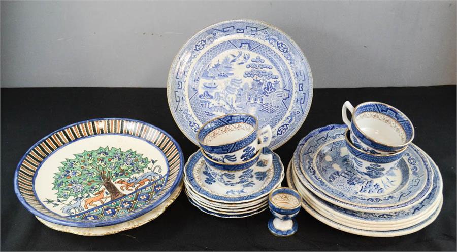 A group of blue and white ceramics including Booths Real Old Willow Pattern cups and saucers.