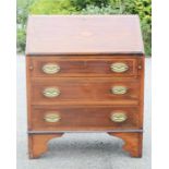 An Edwardian mahogany bureau, with fall front enclosing a fitted interior, three long drawers to the