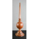 A metallic corinthium needle form column painted with a simulated wood finish, 58cm high.