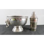 A silver plated punch bowl and cocktail shaker.