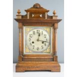 A German oak cased mantle clock, with Arabic dial, with key and pendulum.