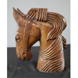A wooden carved horse head.