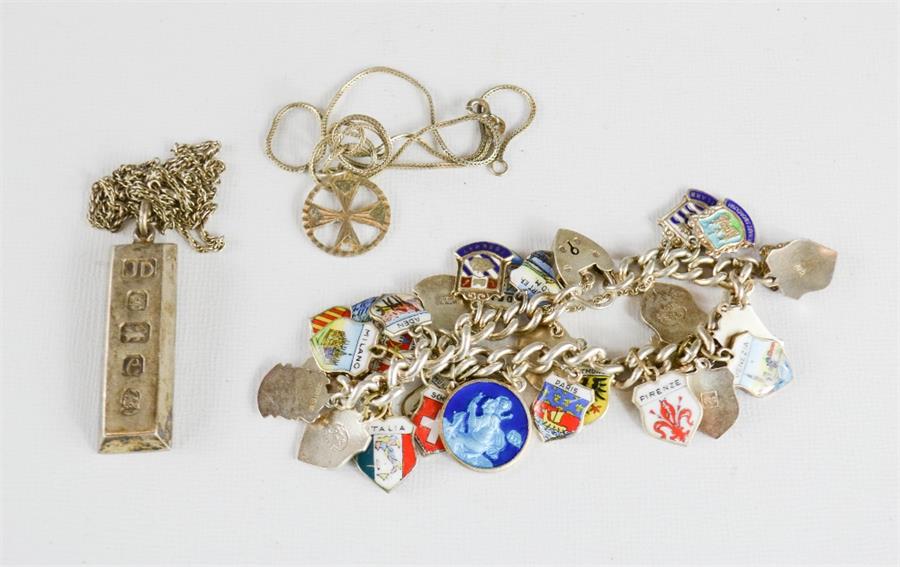 A silver charm bracelet and enamel charms, together with a silver ingot pendant necklace, and a