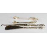 A silver pair of sugar tongs together with a Victorian shoe horn a button hook with matching