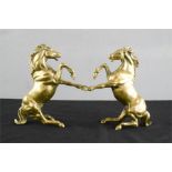 A pair of brass horses.