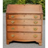 An 18th century oak bureau, the fall front enclosing a fitted interior and one short over three long