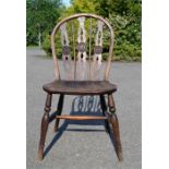 A 19th century single chair, in yew wood, with pierced splats, and H form stretcher.