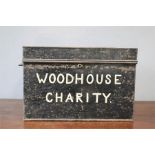 A tin trunk labelled 'Woodhouse Charity'.