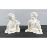 Two plasterwork cherub figures.