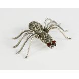 A silver and marcasite spider.