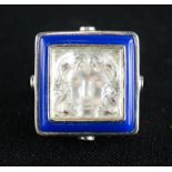 A Lalique Art Deco silver and crystal Masque Du Femme ring, bordered by blue enamel piping with