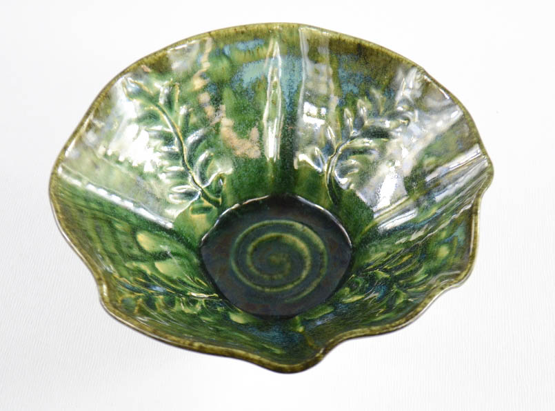 A Studio high fired lustre glazed wavy rimmed bowl by Peter Gerard Starkey, green trailing seaweed