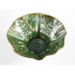 A Studio high fired lustre glazed wavy rimmed bowl by Peter Gerard Starkey, green trailing seaweed