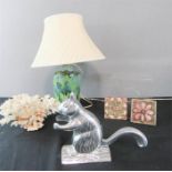 A stoneware glazed studio lamp base, coral, and a steel squirrel nutcracker.
