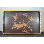 A black lacquered tray depicting two birds, 36 by 58cm.