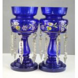 A pair of Victorian blue glass lustres, with enamelled floral decoration. 27cm.