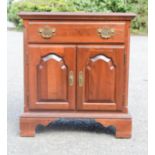 A small mahogany cabinet with single drawer and two cupboard doors.