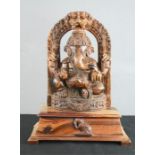 A 19th century carved hardwood figure of a Hindu Deity, Lord Ganesh, on raised pedestal with