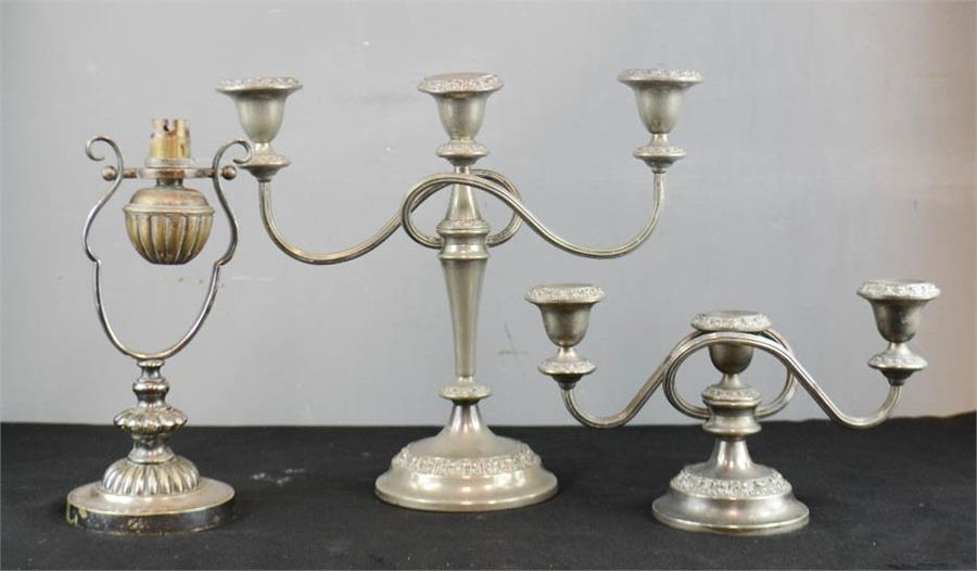 Two silver plated candleabra and a gimble mounted table lamp.