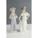 Two Nao Lladro figures; boy with accordian and girl in white dress.