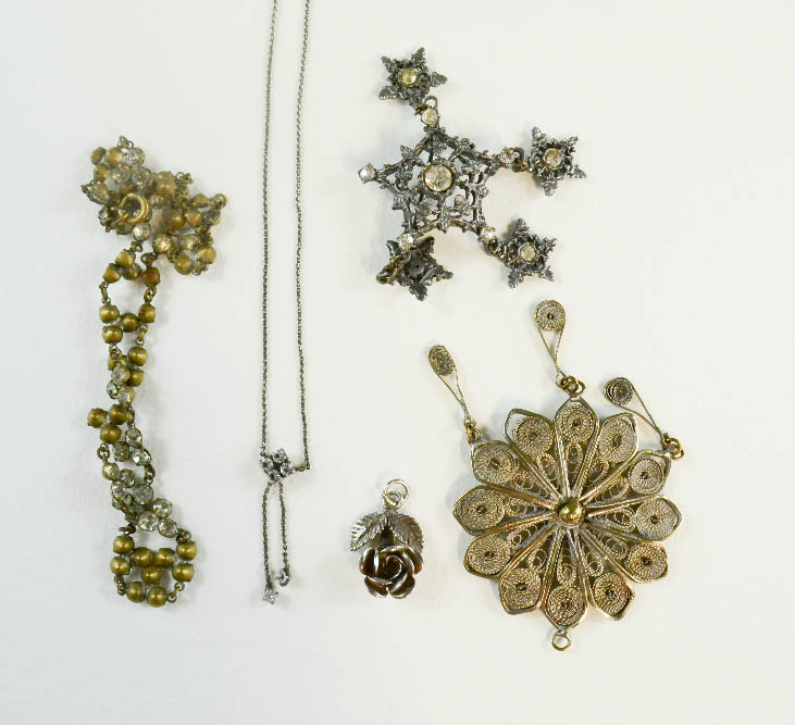 A silver filagree pendant, a necklace, a silver pendant in the form of a rose and paste jewellery.