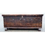 A stained pine blanket chest, with a carved front and a coffee table with ball and claw feet.