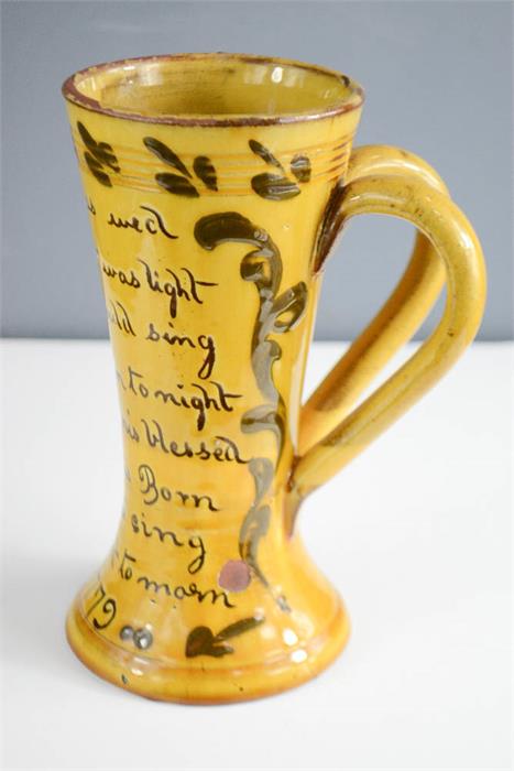 A twin handled slip glazed cup dated 1779, with inscription 'Ere He Was Wed, His Heart was Light,