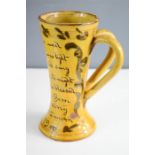 A twin handled slip glazed cup dated 1779, with inscription 'Ere He Was Wed, His Heart was Light,
