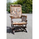 An Edwardian oak rocking chair, upholstered with teddy bear fabric.