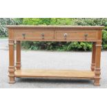 An oak sideboard with long single drawer and fluted column legs.