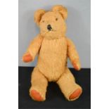 An antique teddy bear, 30cm high.