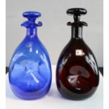 Two Blenko glass decanters, one blue and one amethyst coloured, 26cm high.