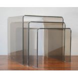 A smoky perspex nest of tables, possibly by Habitat.