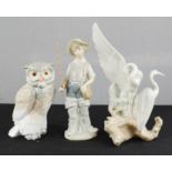 A Lladro fisherman, a Nao herron, and a Nao owl. (3)