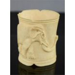 A 19th century Indian carved ivory child's bangle carved with an elephant. 7cm high.