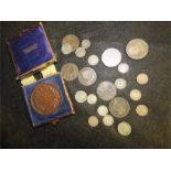 A quantity of coins including three penny pieces, Victorian pennies and others.