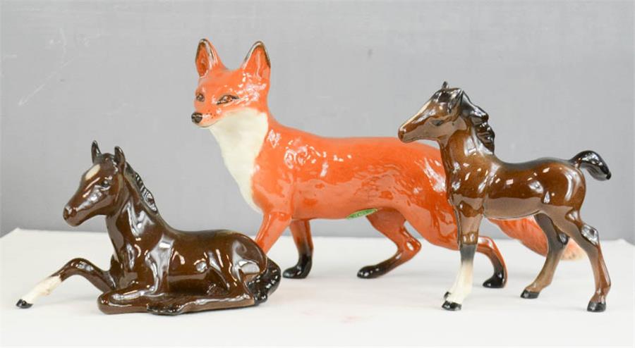 Two Beswick horses and a fox.