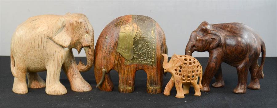 A group of four carved elephants, of differing style and form.