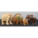 A group of four carved elephants, of differing style and form.