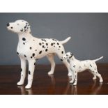 Two Beswick Dalmatians.