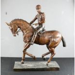 A bronze jockey and racehorse, unsigned, 64 by 60 by 18cm.