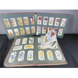 A group of cigarette card albums.
