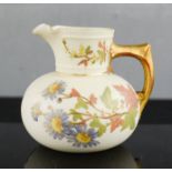 A Royal Worcester porcelain jug, no 1376, hand painted with flowers. 10cm high.