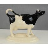 A Bridgwater cow form creamer, with cover. 16cm.