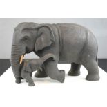 A wooden carved elephant and calf. 21cm high.