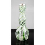 A glass bud vase, with green swirl and silver rim.