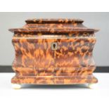 A 19th century tortoiseshell tea caddy of sarcophagus form, 14 by 19 by 11cm.